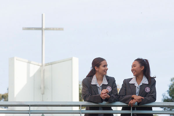 Two Mary MacKillop Catholic College Wakeley students chatting on walkway