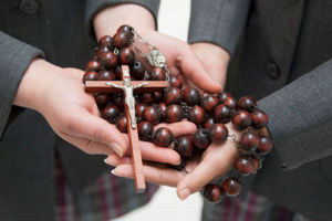 Mary MacKillop Catholic College Wakeley students holding rosary