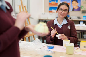 Students painting ceramics in art class at Mary MacKillop Catholic College Wakeley